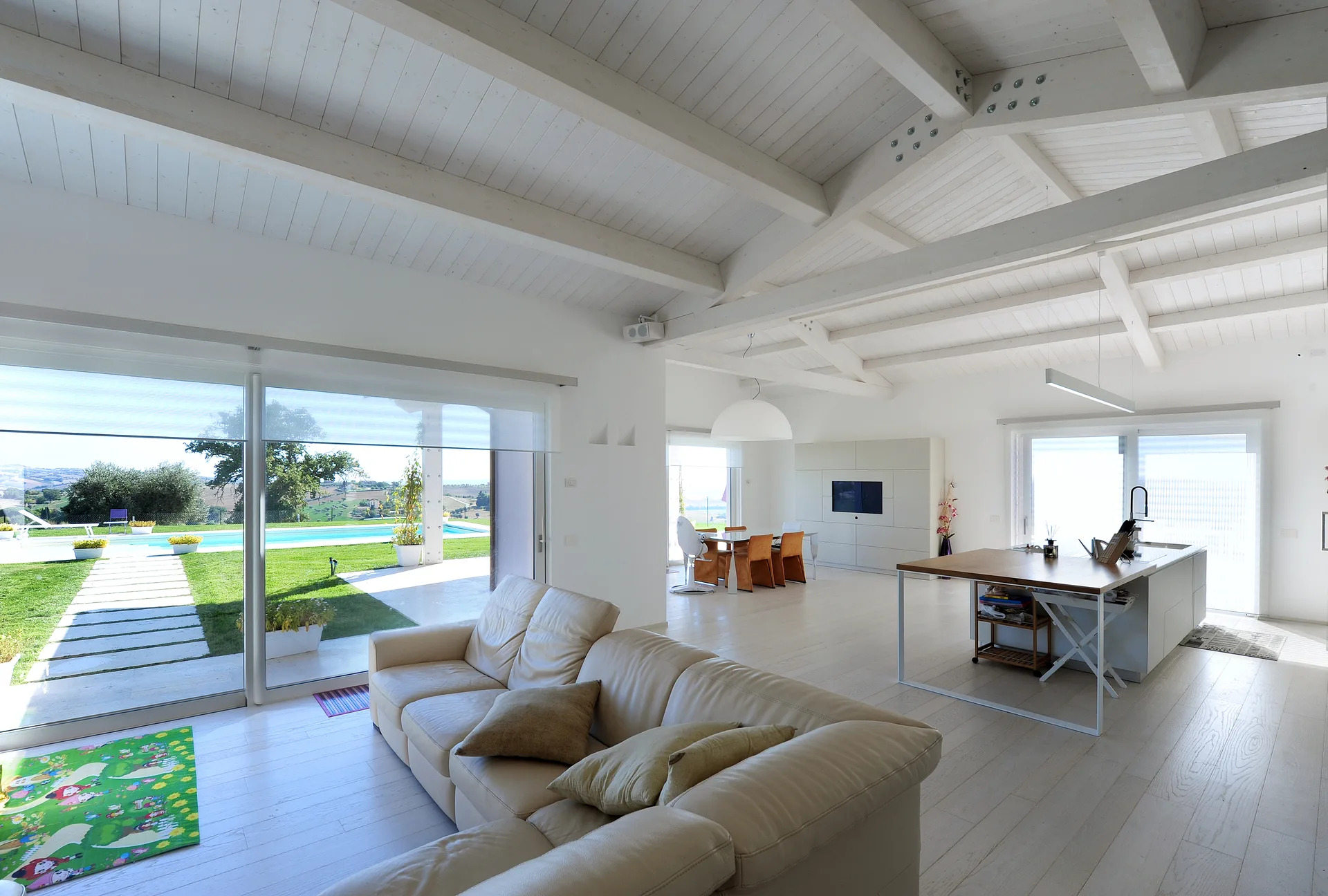 Interno open space moderno e arredato di una casa in legno chiavi in mano con grandi vetrate
